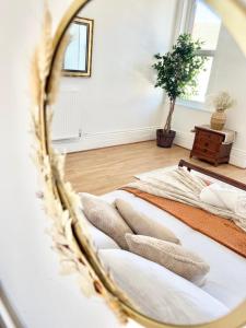 two beds in a room with a mirror at Southsea stays in Portsmouth