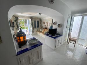 a living room with a couch and a television in it at Magi - Villa Amare in Ponza