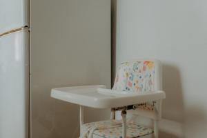 a bathroom with a white sink and a chair at Casa Sousa Ribeiro in Praia da Vitória