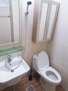a bathroom with a toilet and a sink and a shower at Changdong Property in Seoul