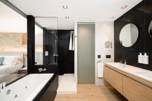 a bathroom with a large tub and a sink at Sir Anthony in Playa de las Americas