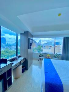 a large bedroom with a view of a city at Arthama Tanah Abang Jakarta in Jakarta