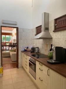 a kitchen with a sink and a stove top oven at Casa Calma in Albufeira