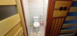 a small bathroom with a toilet in a room at Apartament Leśny in Nowy Targ +14 photos