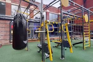 a gym with a punching bag hanging from the ceiling at Village Hotel Cardiff in Cardiff