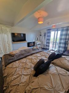 a large bed in a bedroom with pillows on it at The Viewpoint in Deal