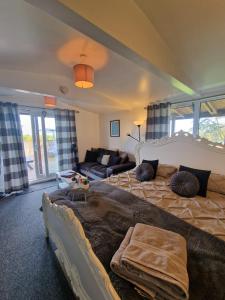 a living room with a large bed and a couch at The Viewpoint in Deal