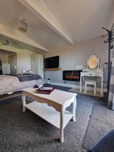 a bedroom with a bed and a table and a fireplace at The Viewpoint in Deal