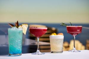 黃金海岸的住宿－衝浪者天堂皇冠假日酒店，坐在桌子上的三杯鸡尾酒