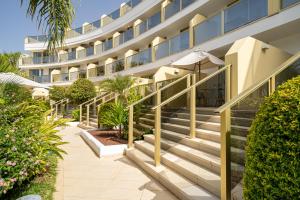 a hotel with stairs leading to the front of a building at Sir Anthony in Playa de las Americas