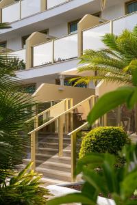 a building with yellow stairs in front of it at Sir Anthony in Playa de las Americas