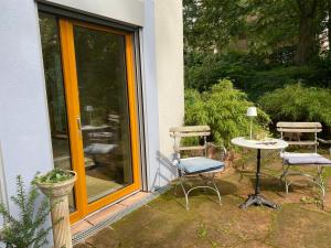 a patio with a table and chairs next to a door at KatharinaS in Pirmasens