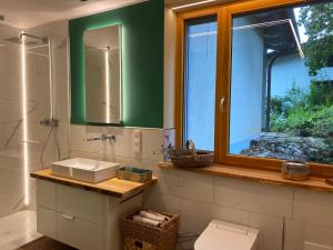 a bathroom with a sink and a mirror and a window at KatharinaS in Pirmasens