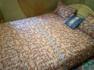 una cama con una almohada y un libro sobre ella en Munyana homestay, en Akagera