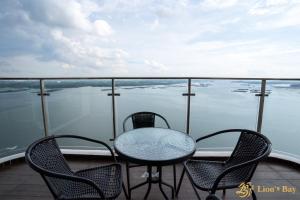 a table and chairs on a balcony with water at Sea View Country Garden Danga Bay by LionsBay in Johor Bahru