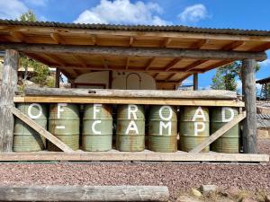 a display of can barrels under a wooden structure at Offroadcamp in Sörsjön