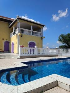 une villa avec une piscine en face d'une maison dans l'établissement V & V ViLLA, à Lalince