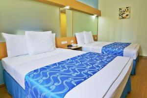 Postel nebo postele na pokoji v ubytování Microtel by Wyndham Davao