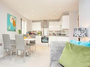 a kitchen and living room with a table and chairs at Number 10, Montpellier Apartments, Teignmouth in Teignmouth