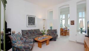 a living room with a couch and a table at Dünenstraße 25 in Zinnowitz