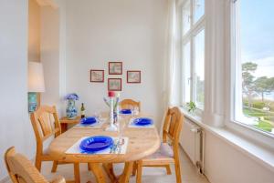a dining room with a wooden table and chairs at Dünenstraße 25 in Zinnowitz +11 photos