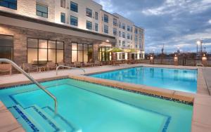 una piscina en un hotel con mesas y sillas en Hyatt House Provo/Pleasant Grove, en Pleasant Grove