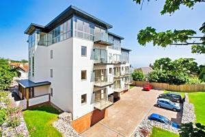 an aerial view of a white building with a parking lot at Number 10, Montpellier Apartments, Teignmouth in Teignmouth