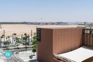 an aerial view of a building with a parking lot at Elegant Studio In Oasis in Abu Dhabi