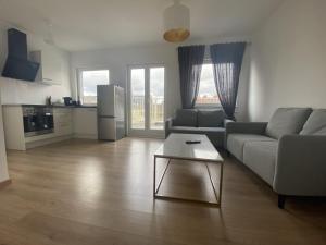 a living room with a couch and a table at Air Apartments 2 in Bremen