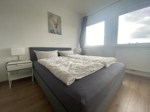 a large bed in a bedroom with a window at Air Apartments 2 in Bremen