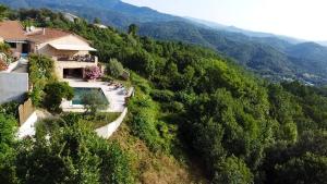 a house on a hill with a swimming pool at Villa de 4 chambres avec piscine privee jacuzzi et jardin clos a Prades in Prades
