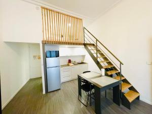 a kitchen with a staircase and a table in a room at Lodge Nicolas, Hyper Centre in Nantes +6 photos