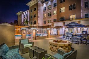 a patio with chairs and a fire pit in front of a building at Residence Inn by Marriott Savannah Airport in Savannah