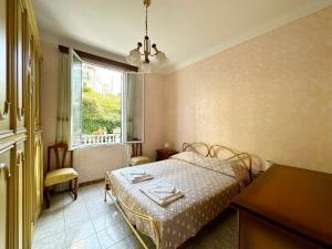 Schlafzimmer mit einem Bett und einem Fenster in der Unterkunft CASA DI LUCA - Le Sorelle - A 1 Minuto Dal Centro in Sanremo