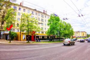 a car driving down a city street with buildings at Tourist Inn in Petrozavodsk