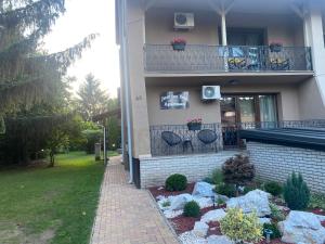 a house with two chairs on a balcony at Just for You in Nyíregyháza +5 photos