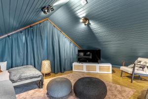 a living room with a tv and a couch and a table at The Angels House in Selfoss