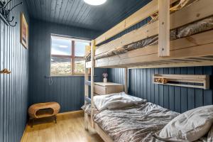 a bedroom with blue walls and a bunk bed at The Angels House in Selfoss