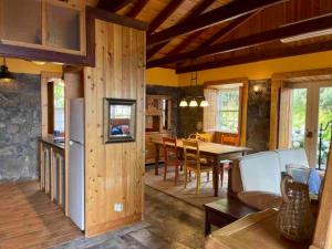 a kitchen and dining room with a table and chairs at Casa da Terra Alta in Santo Amaro