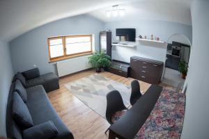 a living room with a couch and a table at Apartament - Bystra in Bystra