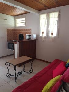 a living room with a couch and a table at F1 studio Martinique in Quartier la Fleury Guiné