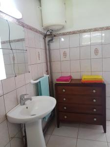 a bathroom with a sink and a toilet and a mirror at F1 studio Martinique in Quartier la Fleury Guiné