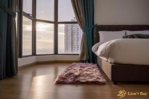 a bedroom with a bed and a large window at Sea View Country Garden Danga Bay by LionsBay in Johor Bahru