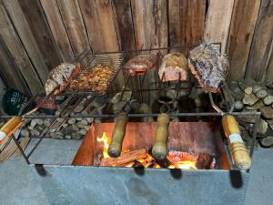 a grill with meat and other food on it at Casa dos Ingleses nos Canyons in Praia Grande