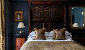 a bedroom with a large bed with a wooden headboard at Batty Langley's in London