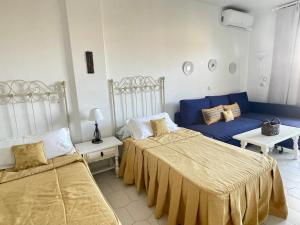 a bedroom with two beds and a couch at Benal Beach Rentals in Benalmádena +48 photos