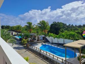 an aerial view of a swimming pool with palm trees at Cosy Two Bedroom Apartment in Grand Gaube