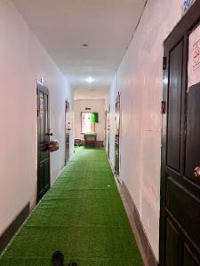 a hallway with a green carpet in a room at Vientiane Star Hotel in Vientiane