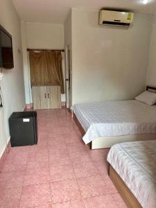 a room with two beds and a tv in it at Vientiane Star Hotel in Vientiane