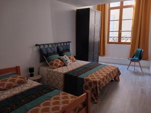 a bedroom with two beds and a window at T2 60 m² - Au cœur de tout in Gignac